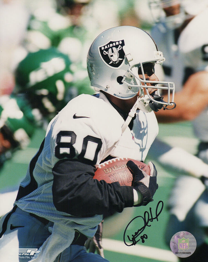 Desmond Howard Signed Raiders White Jersey Close Up With Football 8x10 Photo - HOW08P304 - Desmond Howard Signed Raiders White Jersey Close Up With Football 8x10 Photo product image