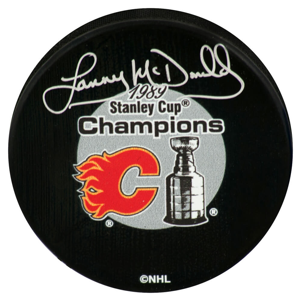 Lanny McDonald Signed Calgary Flames 1989 Stanley Cup Champions Logo Hockey Puck - MCDPUC414 - Lanny McDonald Signed Calgary Flames 1989 Stanley Cup Champions Logo Hockey Puck product image